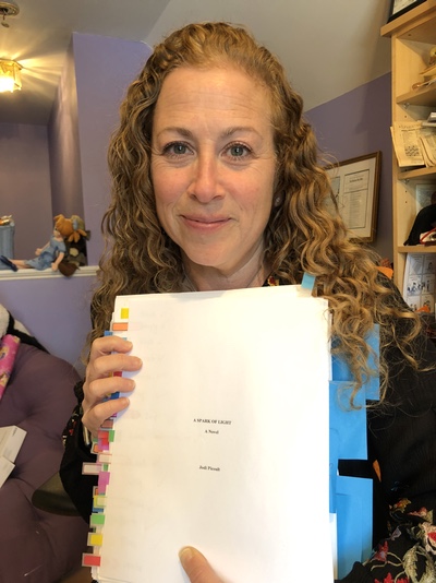 Jodi with her manuscript for A Spark of Light